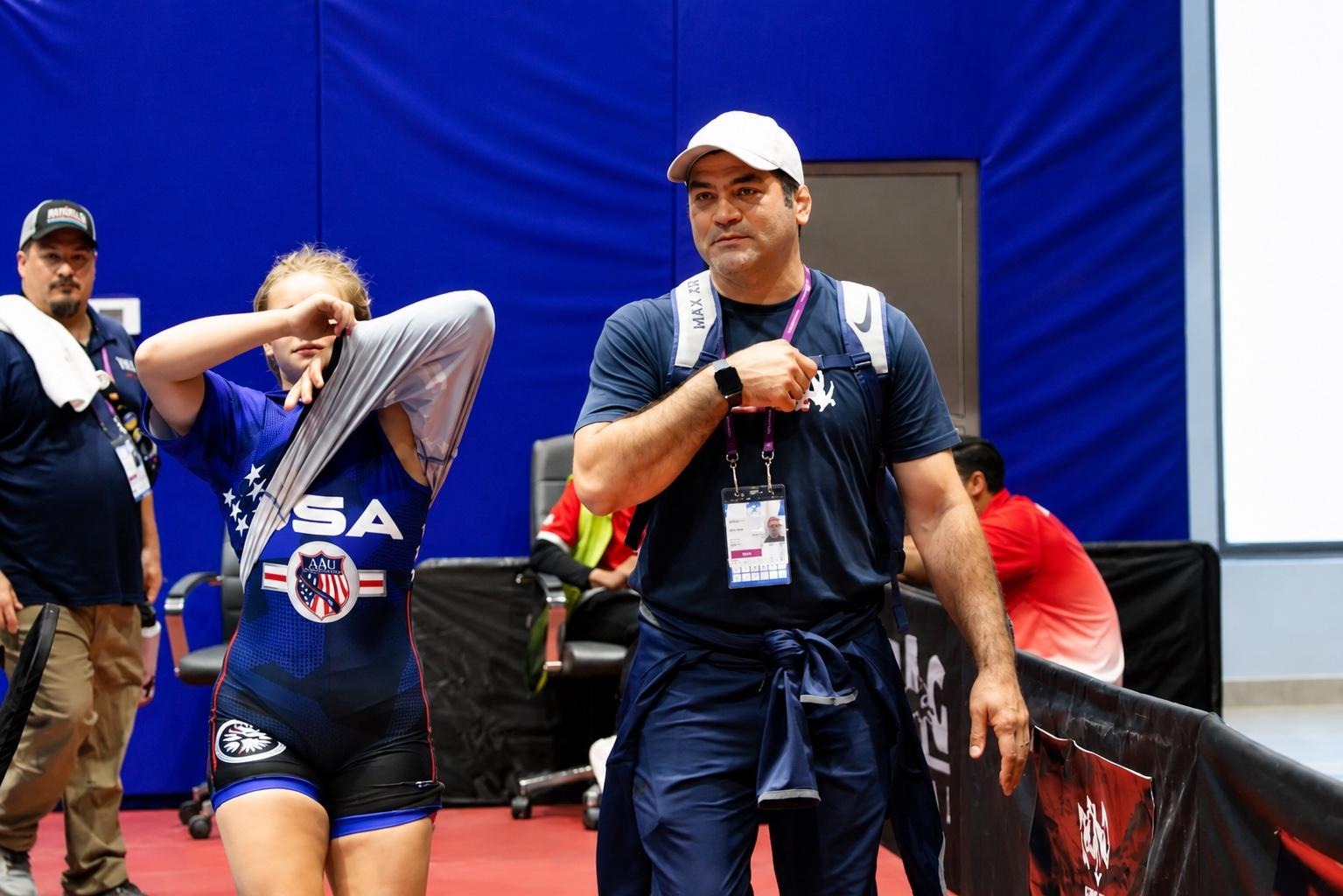 Mostafa Alizadeh accompanying an athlete at a wrestling competition