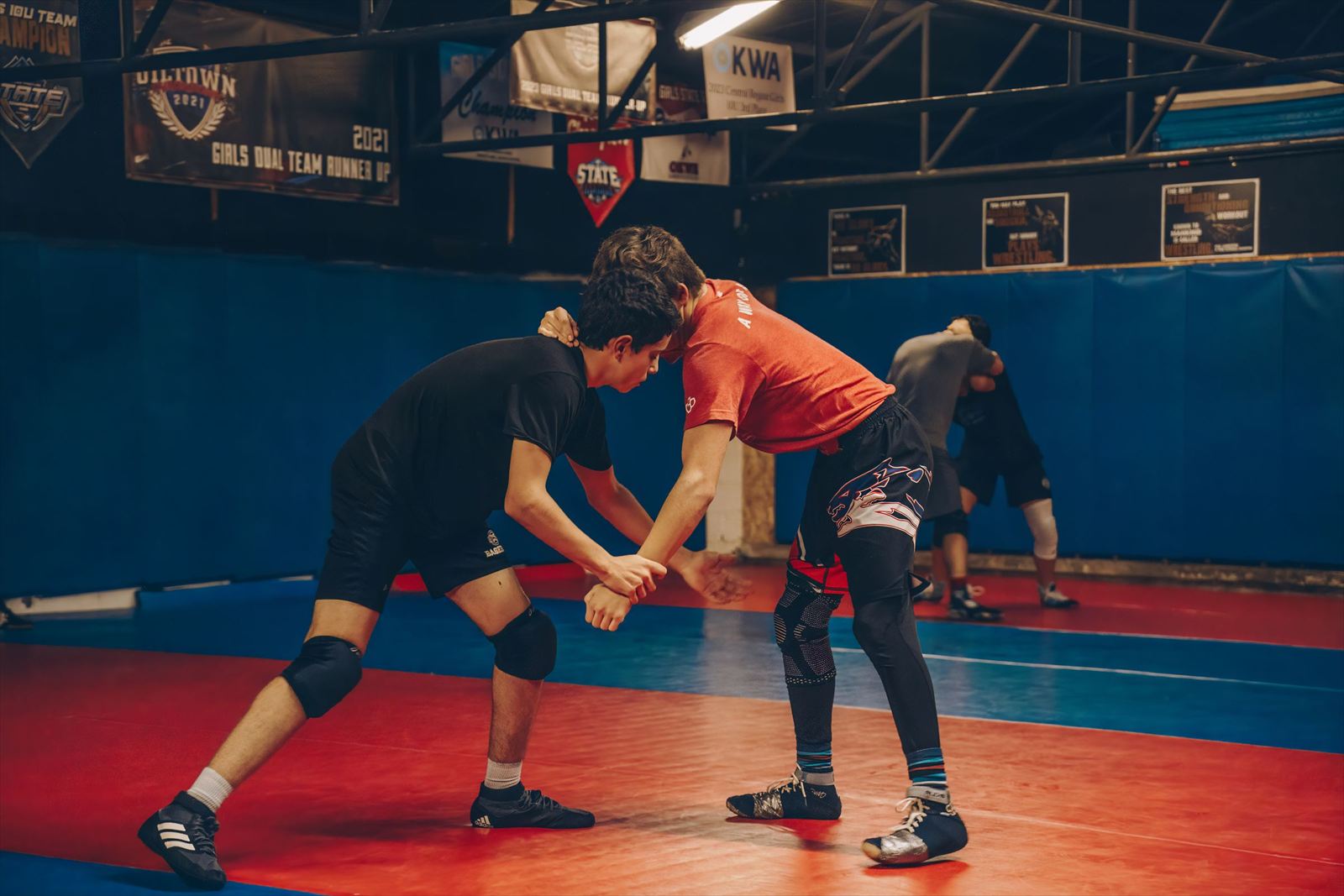 Strikers athletes ages 10–14 training on the wrestling mat